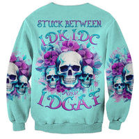 Turquoise crewneck sweatshirt with large skull, flowers, and neon text graphic