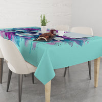 Blue tablecloth with colorful floral skull print across dining table