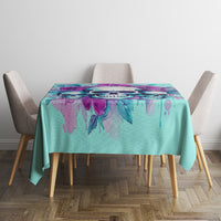 Blue tablecloth with purple floral skull motif, centered on dining table