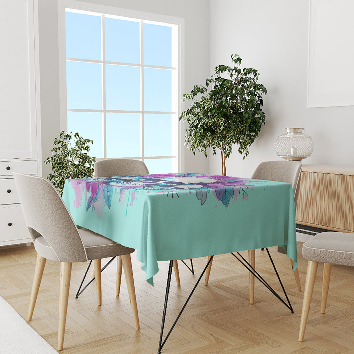 Blue tablecloth with dripping floral skull artwork across dining table