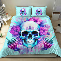 Aqua duvet and two pillows with skull face, purple flowers, and ornamental butterfly details