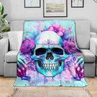 Blue skull floral blanket draped on a sofa, featuring purple flowers around the skull