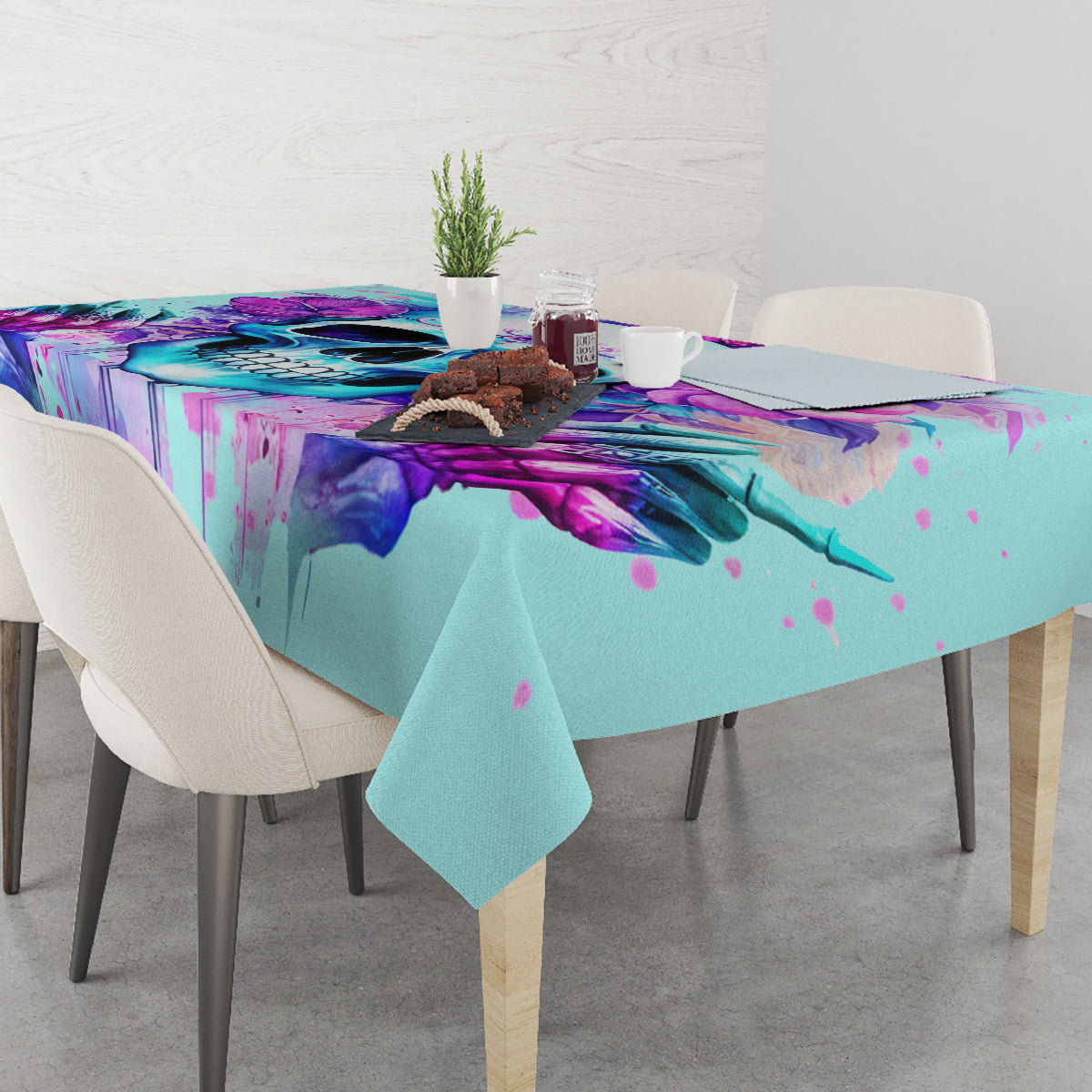 Blue tablecloth on dining table with purple skull mural and splatter accents