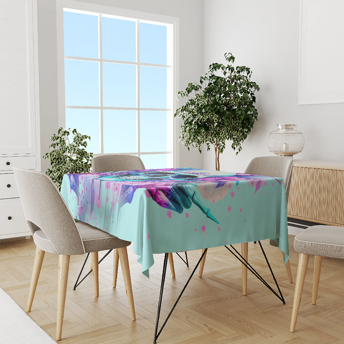 Blue tablecloth over dining table with purple, pink, and teal skull graphic