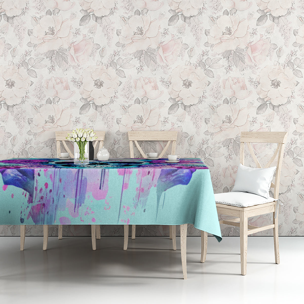 Blue tablecloth on table against floral wall pattern, purple skull artwork panel