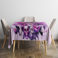Pink skull tablecloth covering table with purple skull, roses, and splatter pattern