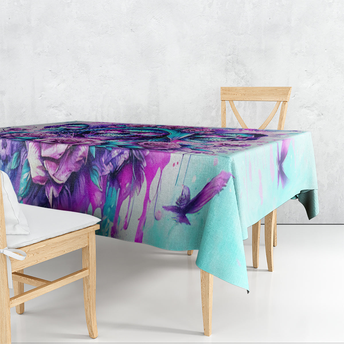 Blue-toned tablecloth with purple and teal skull angel floral print, draped edge