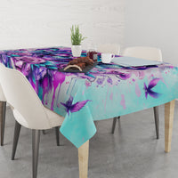 Blue-toned tablecloth on dining table with purple skull angel floral design