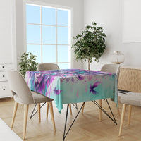 Blue-toned tablecloth with purple skull angel floral pattern covering dining table