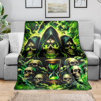 Green skull and hourglass flame blanket, spread across gray sofa