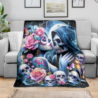 Skull couple blanket draped on sofa; blue lightning, roses, skulls and butterfly details