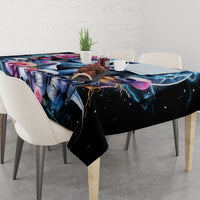 Black skull and rose tablecloth with corners hanging over a dining table