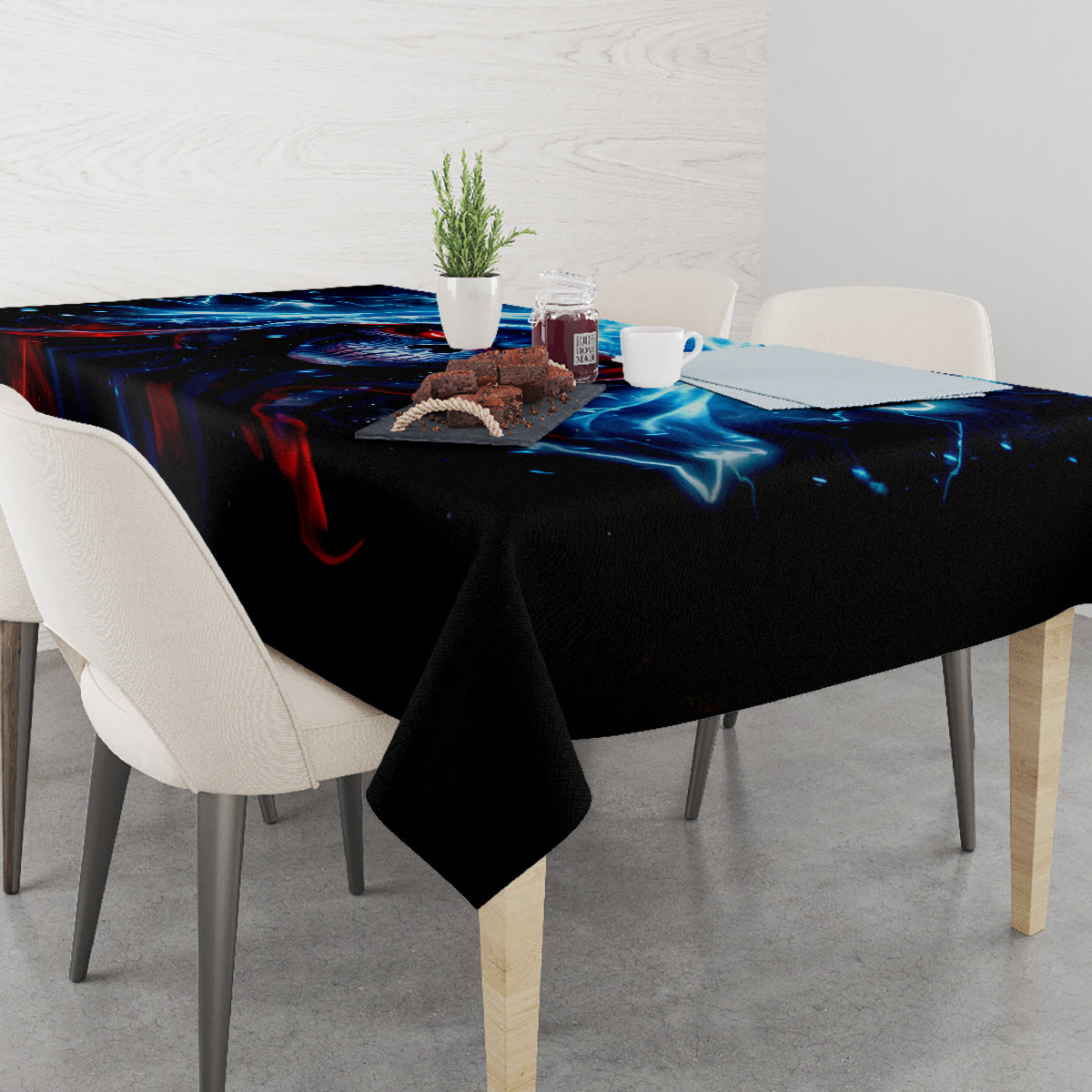 Black tablecloth with blue lightning skull design covering a dining table.
