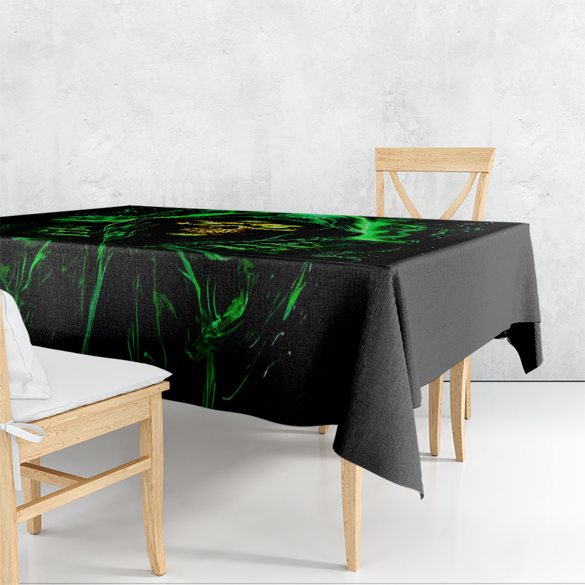 Black tablecloth with neon green flame skull graphic draped over dining table