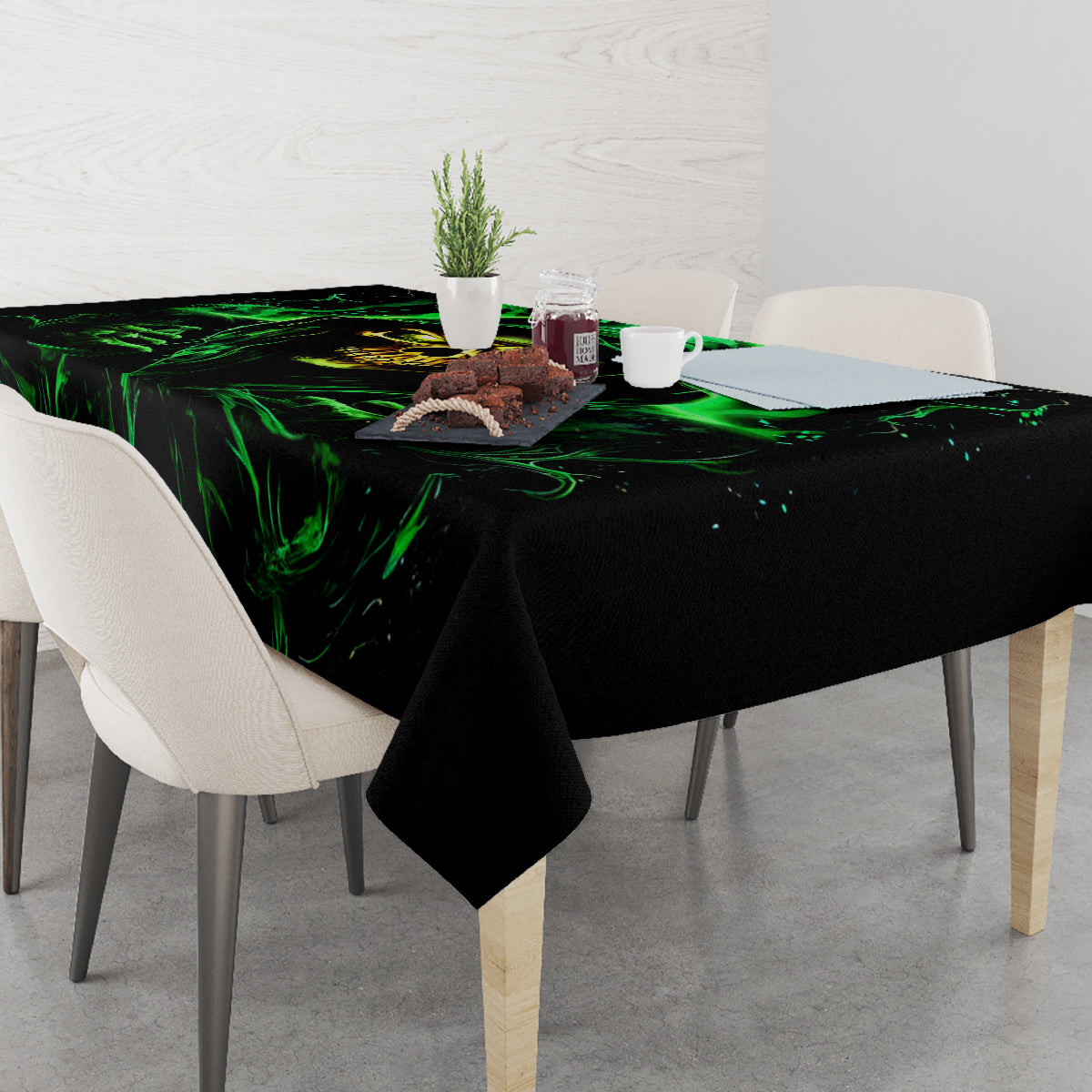 Black skull tablecloth with neon green flame design covering dining table top