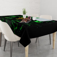 Black skull tablecloth with neon green flame design covering dining table top