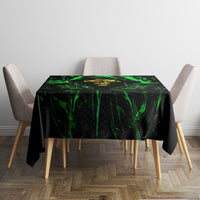 Black rectangular tablecloth with neon green flame skull illustration on tabletop