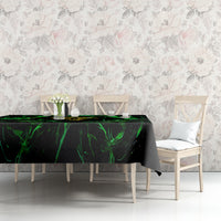 Black tablecloth with neon green flame skull artwork across dining table