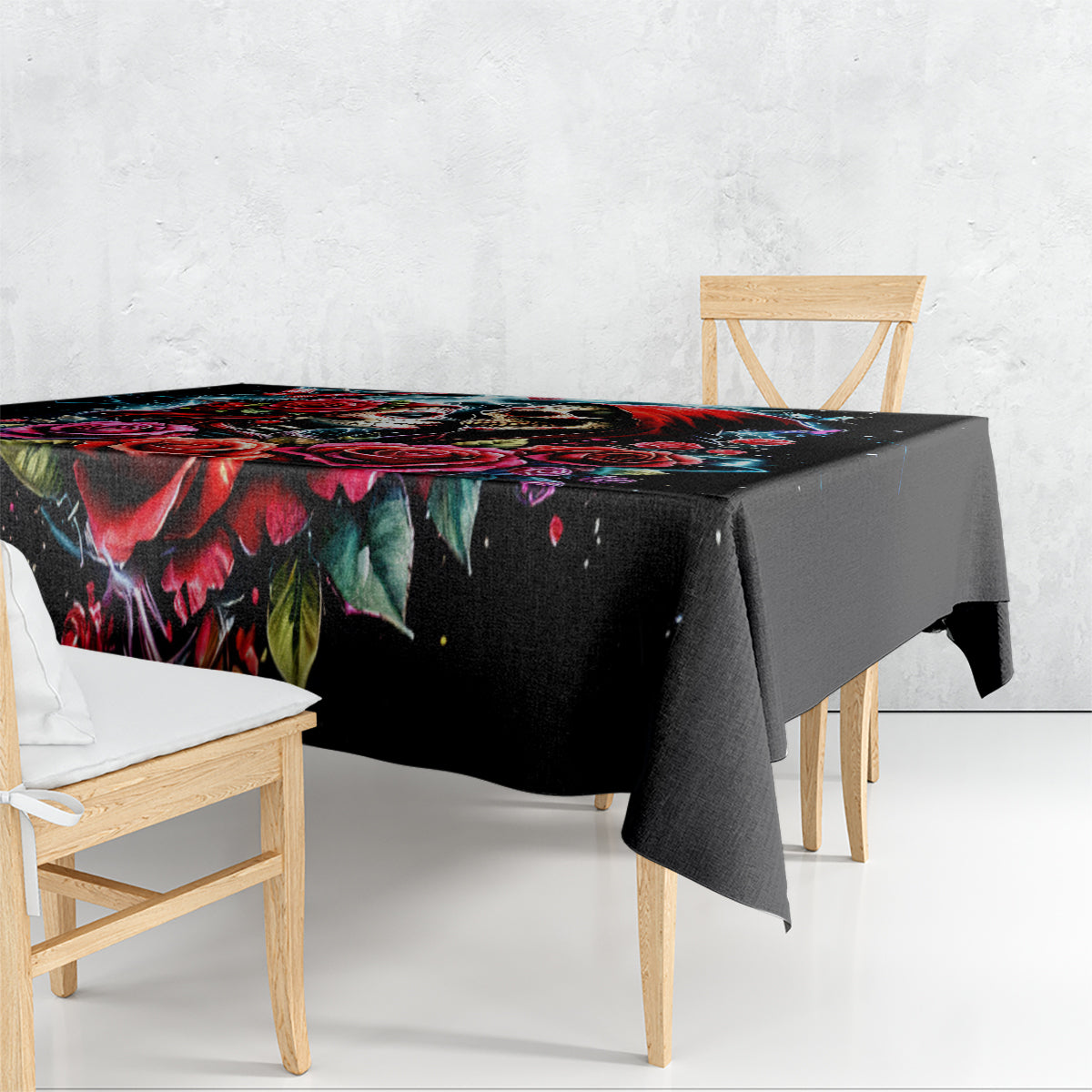 Black tablecloth with skull and rose pattern draped over table edge