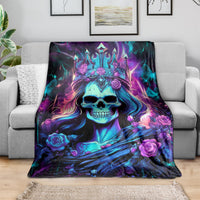 Skull queen throw blanket draped on a sofa, purple and blue skull with rose accents