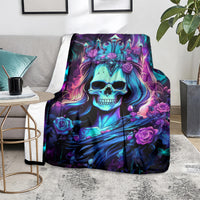 Skull queen blanket spread on the floor, blue skull, purple roses, and butterfly accents