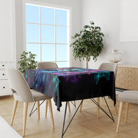 Black tablecloth on dining table featuring purple-blue skull and teal butterfly art