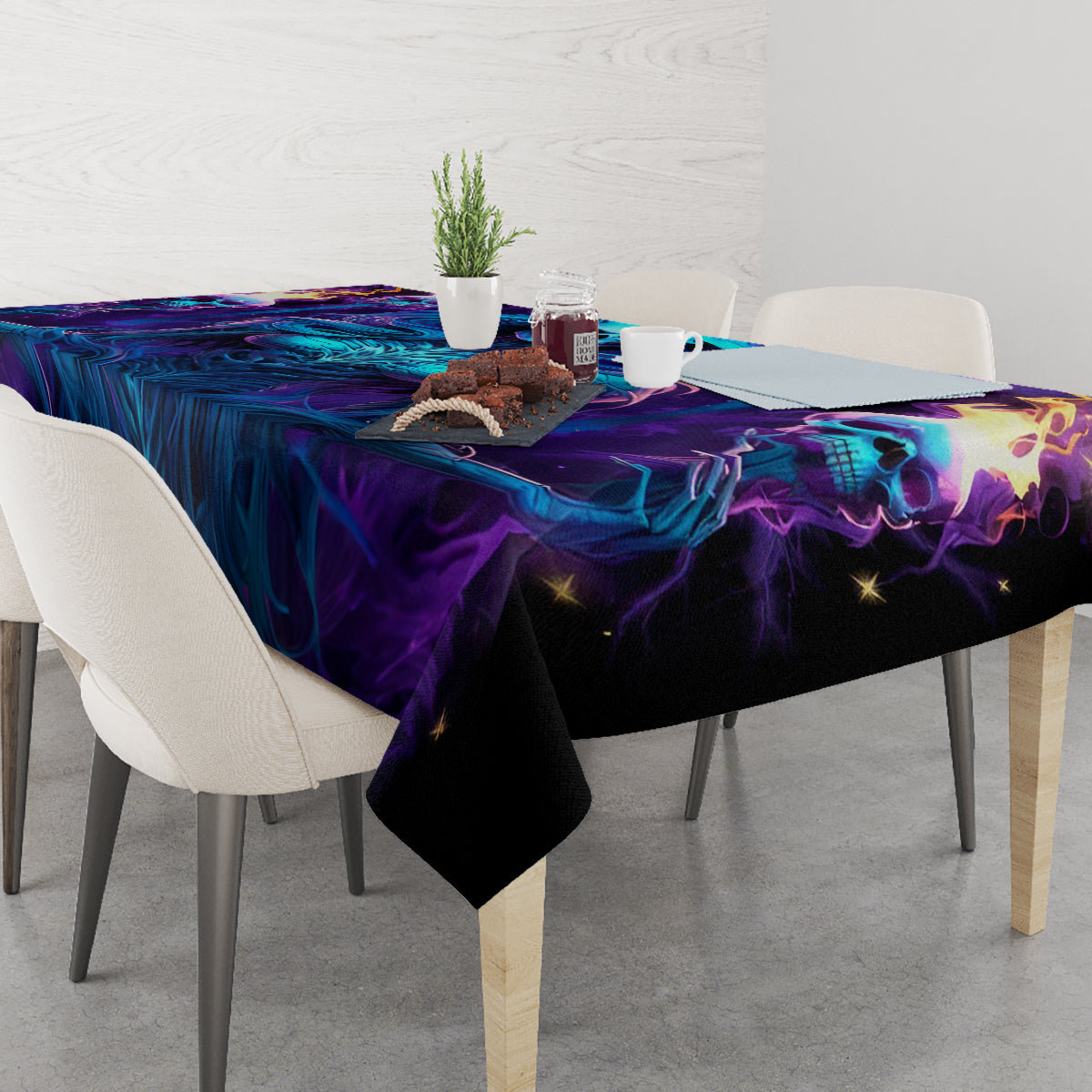 Halloween tablecloth on dining table corner view, black with blue-purple skull graphics