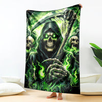 Green flame skull reaper blanket featuring glowing eyes, skeleton hand, and chain design