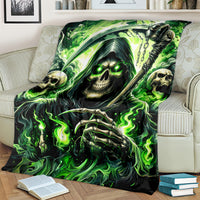 Green flame skull reaper blanket with glowing-eyed skull and chain, draped on couch