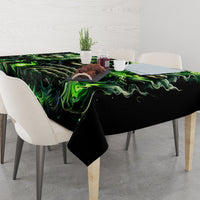 Black skull tablecloth with vivid green flame pattern covering dining table