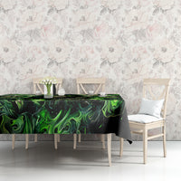Black skull tablecloth with green flame artwork, set on dining table surface