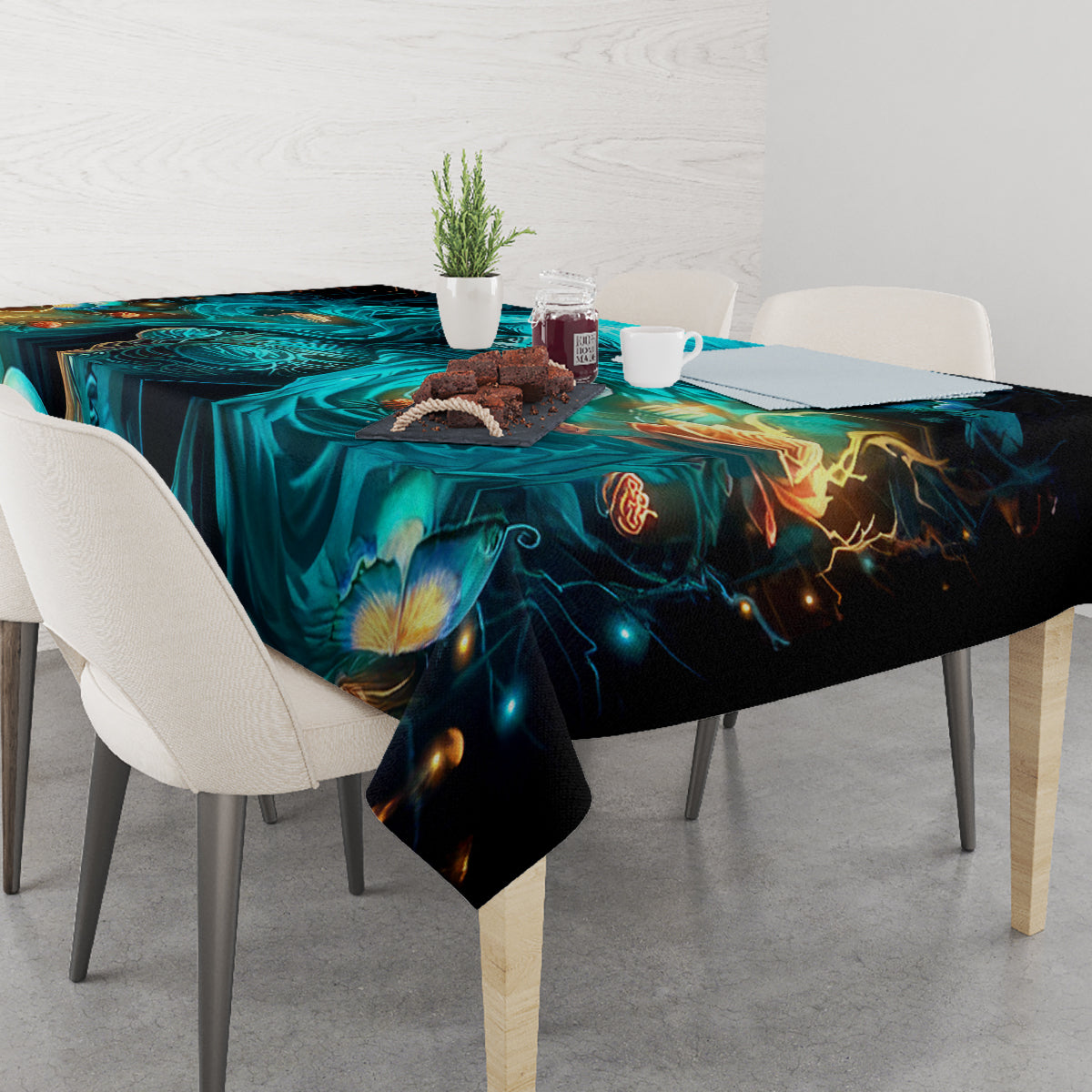 Black tablecloth with teal skull and warm amber flame details, corner drape view