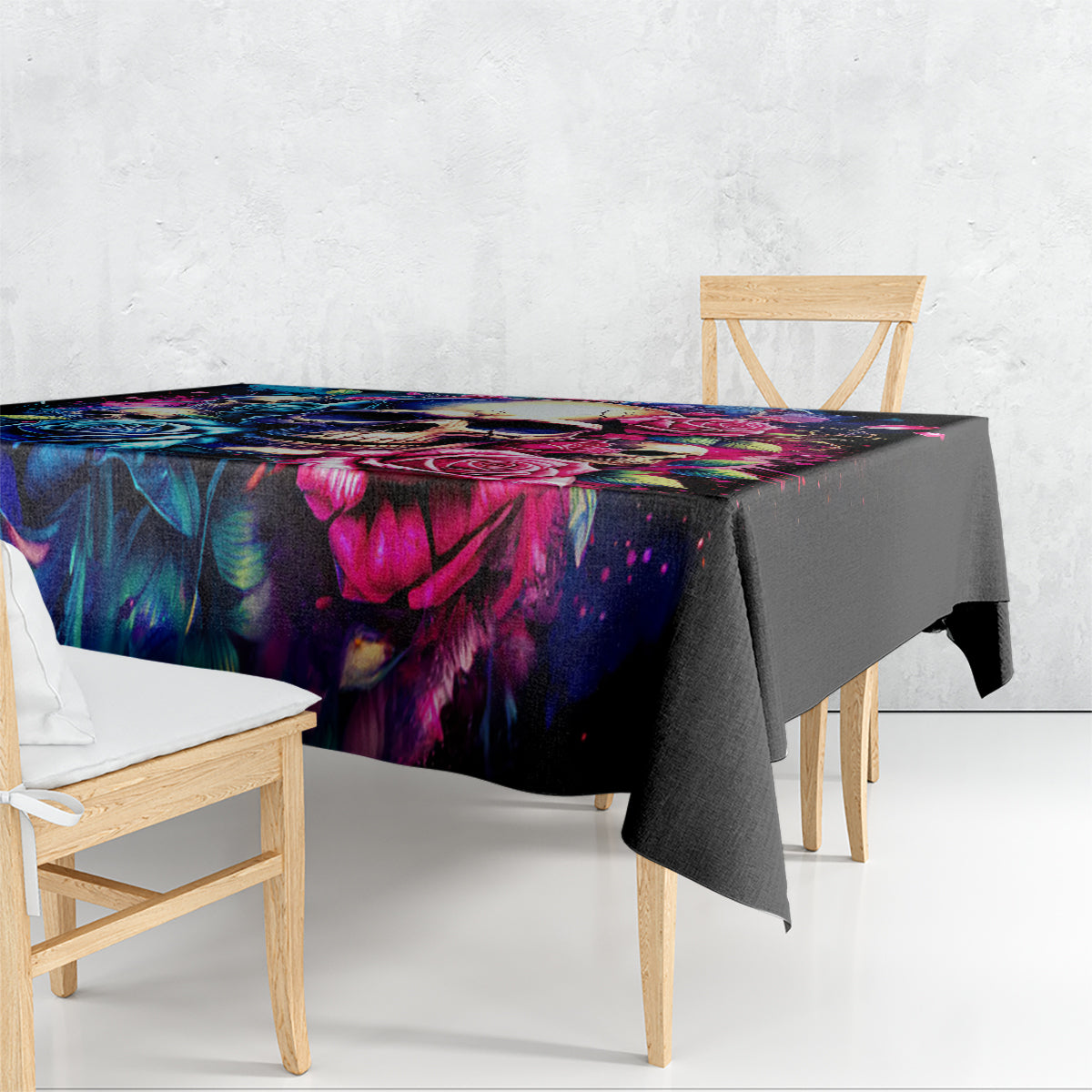 Black tablecloth with vibrant skull-and-rose print, draped over dining table