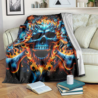 Blue and orange flame skull blanket with black border, draped over couch and chair