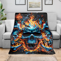 Flame skull blanket draped on gray sofa, blue skull with orange fire details