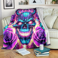 Skull graphic fleece blanket with purple roses and teal flames, draped on a couch