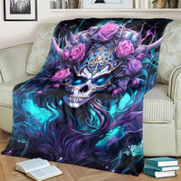Black skull and rose graphic blanket folded over couch arm, blue-purple skull and pink roses