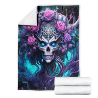 Black skull and rose graphic blanket shown folded, blue-purple skull with pink roses and horns