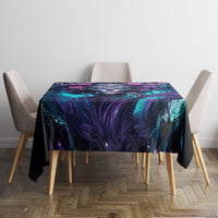 Black tablecloth with teal and purple abstract skull artwork on a dining table