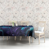 Black tablecloth with teal and purple abstract skull design on a dining table and chairs