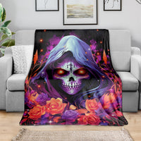 Black hooded skull rose blanket draped over a gray sofa