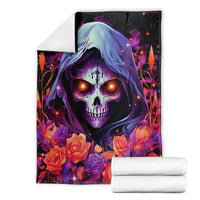 Black hooded skull rose blanket with a folded stack of white towels