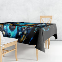 Black tablecloth draped on wooden table with blue wolf skull artwork