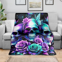 Skull and rose print blanket in purple, teal, and blue on a couch