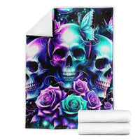 Folded skull and rose throw blanket with teal glowing light and purple roses