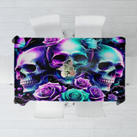 Black skull-and-rose print tablecloth with bright purple and teal motif, folded edge view