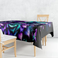 Black skull and rose print tablecloth draped on table with vivid purple and teal design