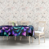 Black skull and rose print tablecloth on long table with purple and teal artwork