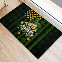 Black rubber doormat featuring skull in green hat with shamrock and gold coin design
