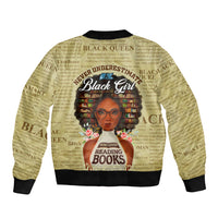 Tan unisex bomber jacket with black rib trim and front zipper, graphic of Black girl reading books